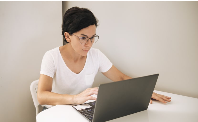Eine Personalerin macht am Laptop einen Background Check von einem Bewerber.